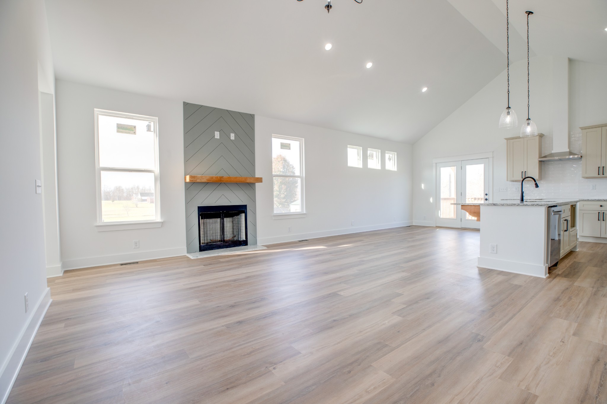 2802 Lock Hollow Road Dickson, TN 37055 - Photo 8 of 34 an empty room with wooden floor fireplace and windows