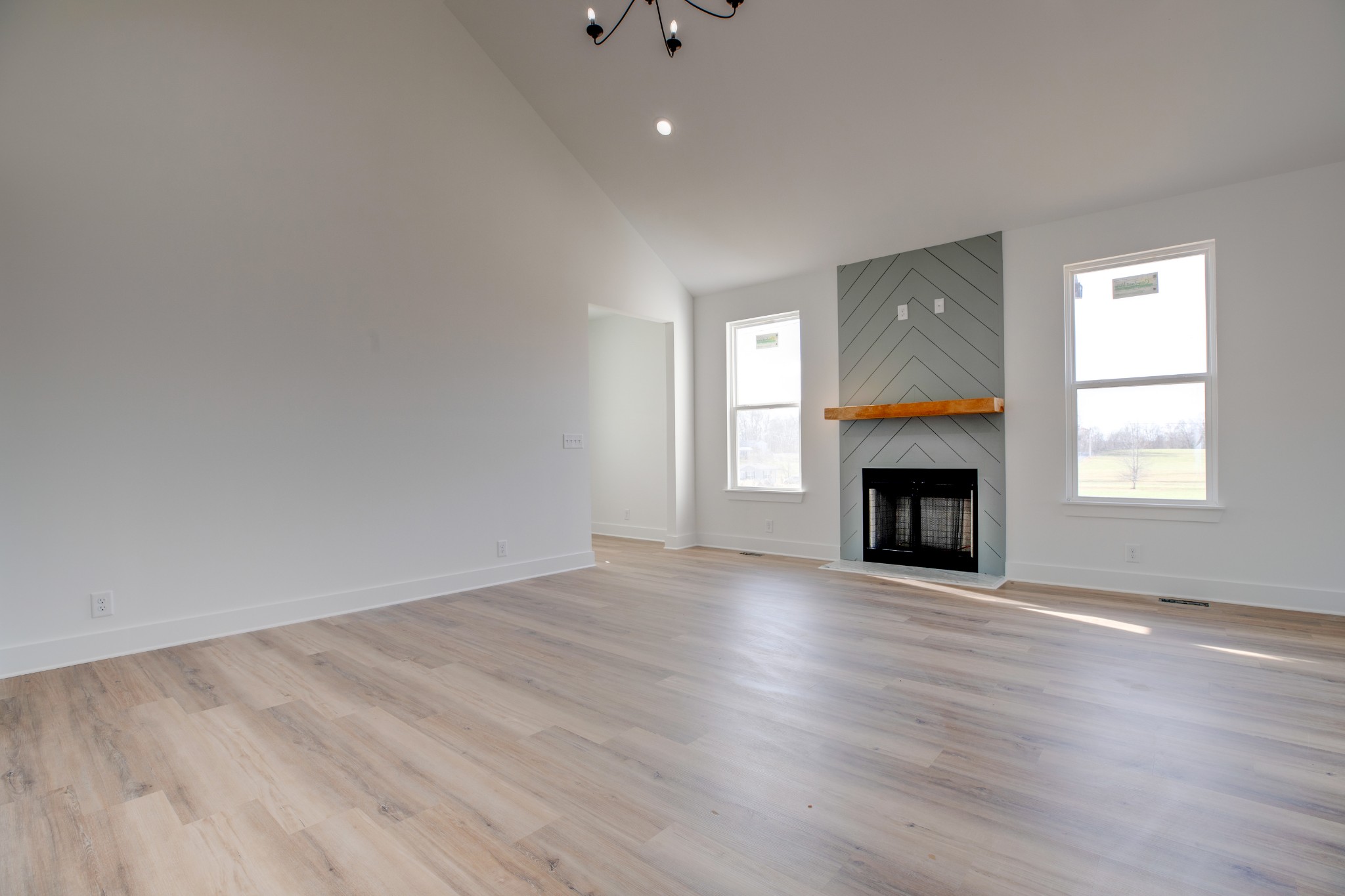 2802 Lock Hollow Road Dickson, TN 37055 - Photo 9 of 34 an empty room with wooden floor fireplace and windows