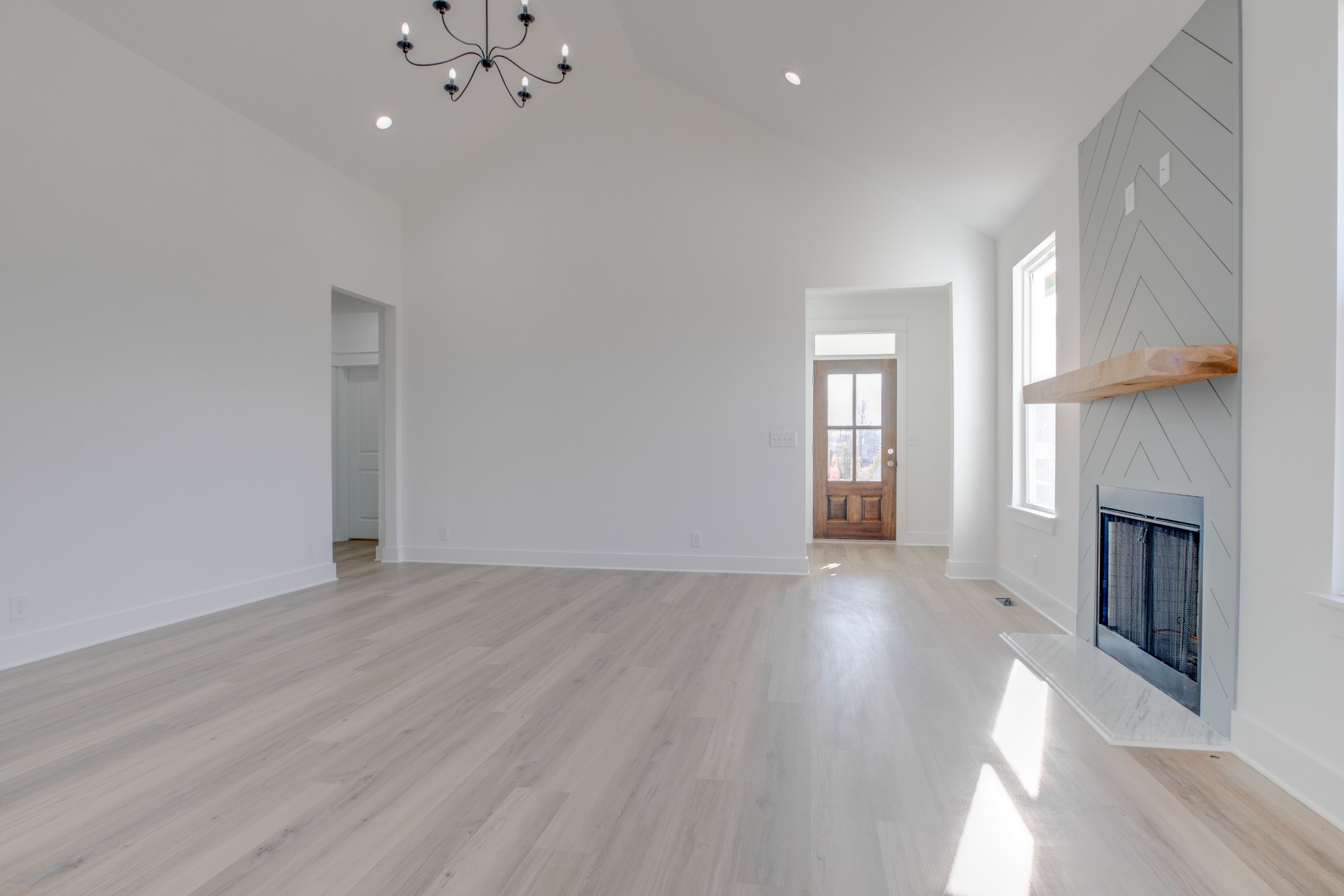 2802 Lock Hollow Road Dickson, TN 37055 - Photo 10 of 34 an empty room with wooden floor and fireplace