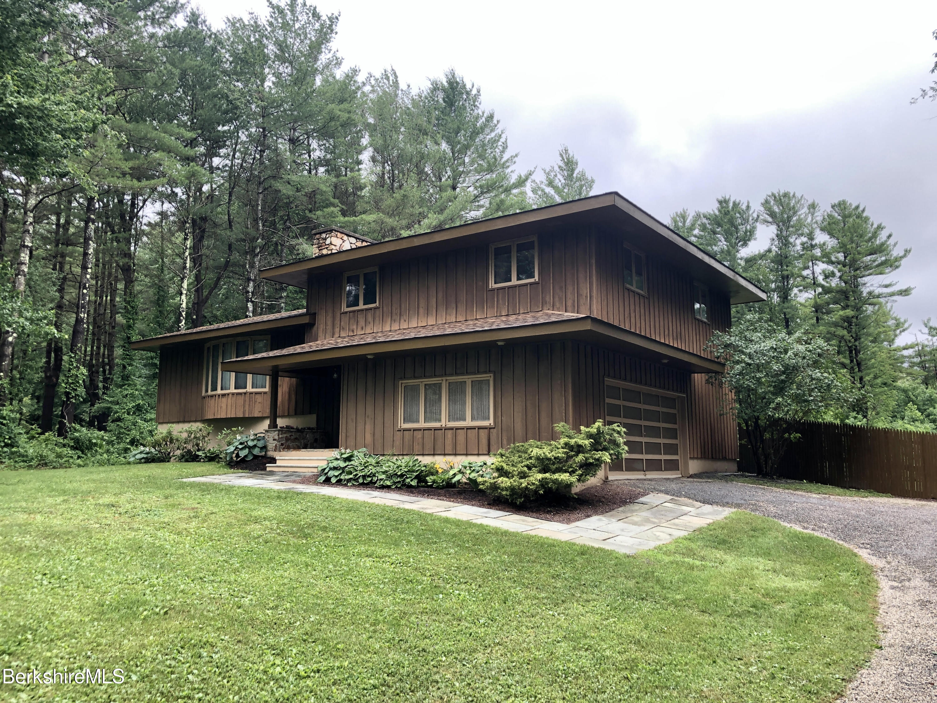 35 Pine Knoll Road Lenox, MA 01240 - Photo 1 of 26 a front view of a house with garden