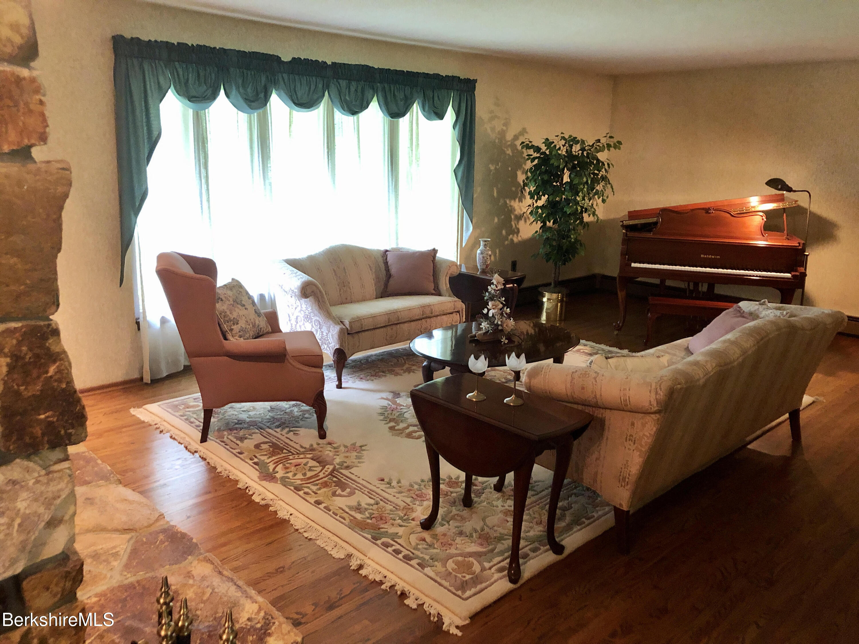 35 Pine Knoll Road Lenox, MA 01240 - Photo 4 of 26 a living room with furniture and a fireplace
