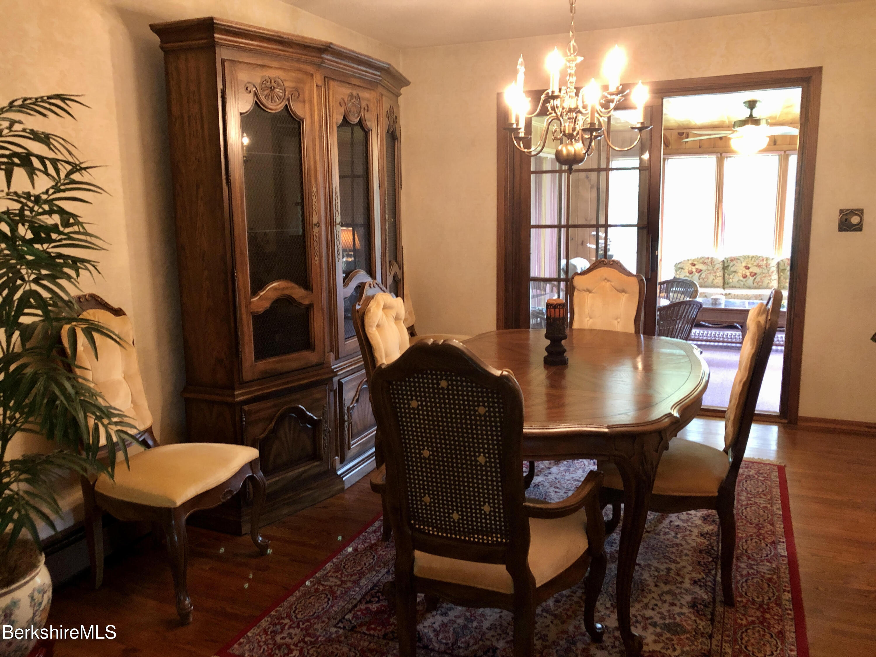 35 Pine Knoll Road Lenox, MA 01240 - Photo 6 of 26 a dining room with furniture a chandelier and wooden floor