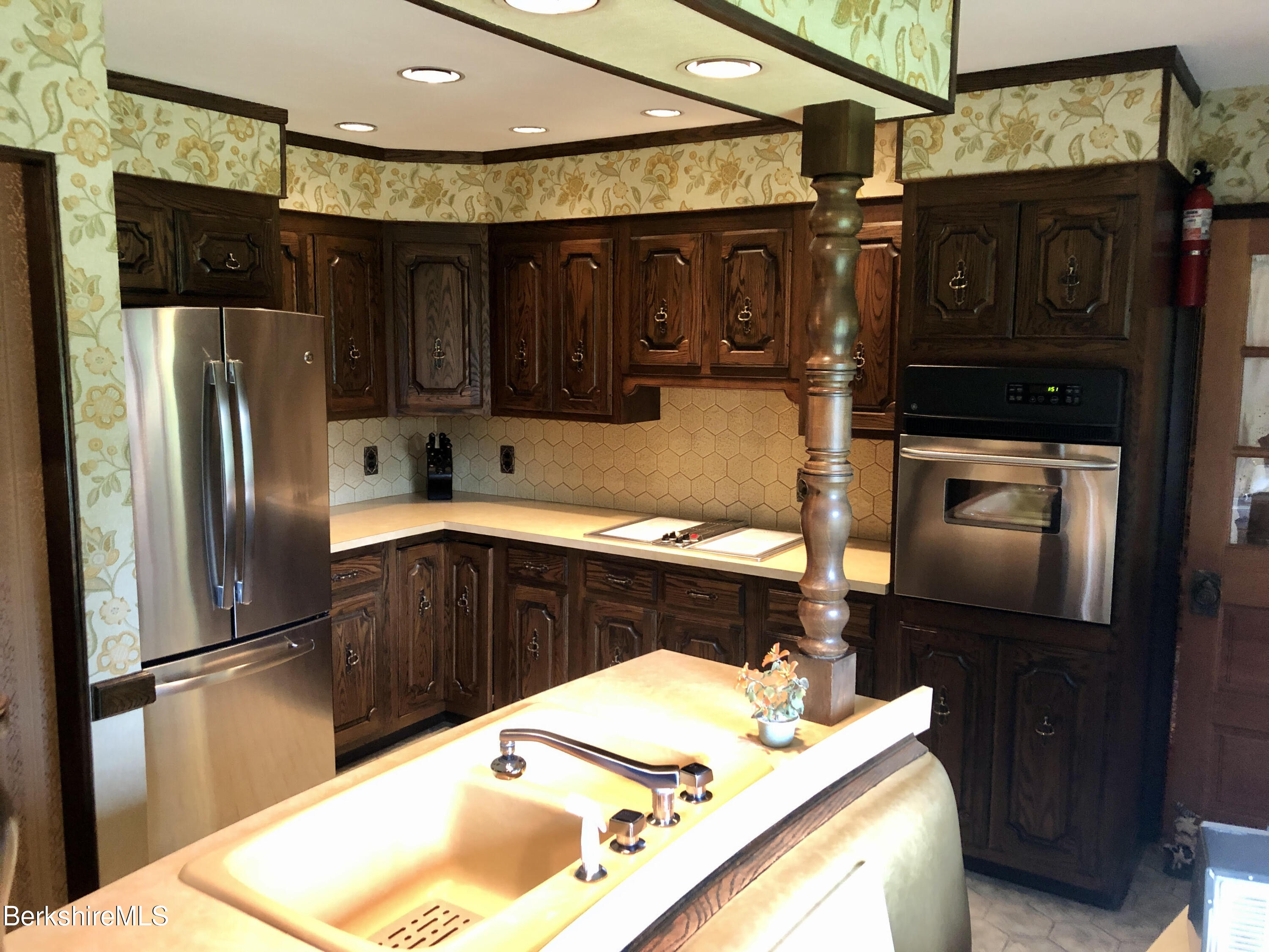 35 Pine Knoll Road Lenox, MA 01240 - Photo 7 of 26 a kitchen with a refrigerator and a sink