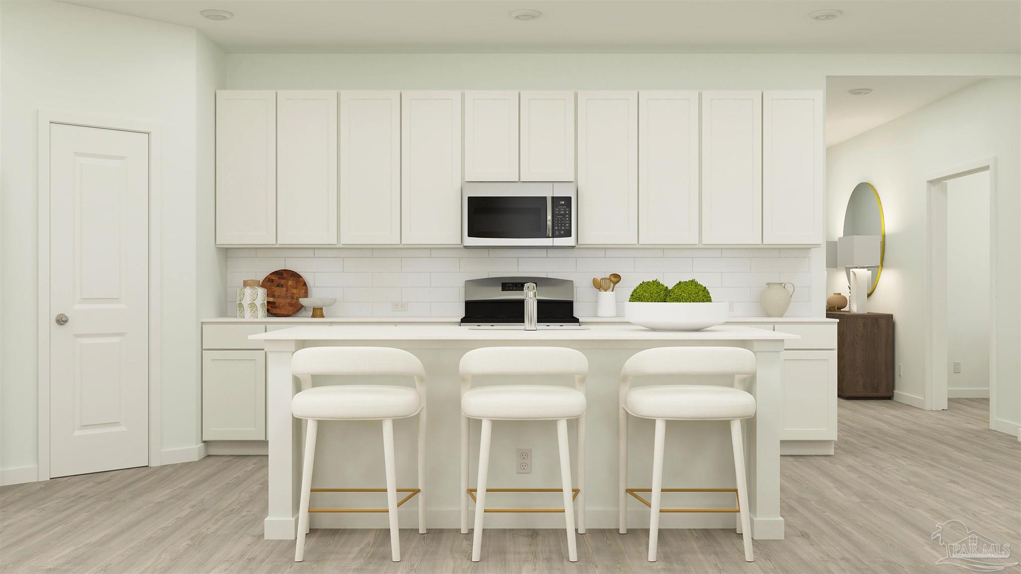 4734 Bald Eagle Road Pace, FL 32571 - Photo 2 of 22 a white kitchen with a sink and cabinets