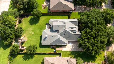 an aerial view of a house with swimming pool garden and patio