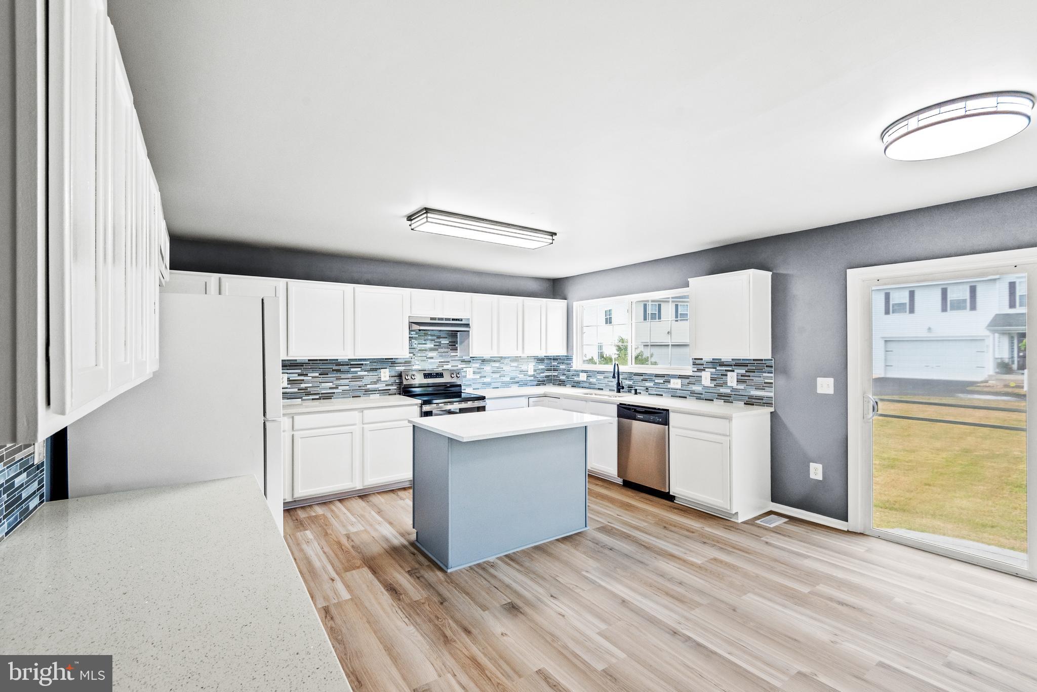 30 Stanley Loop Fredericksburg, VA 22406 - Photo 11 of 45 a kitchen with a refrigerator and white cabinets
