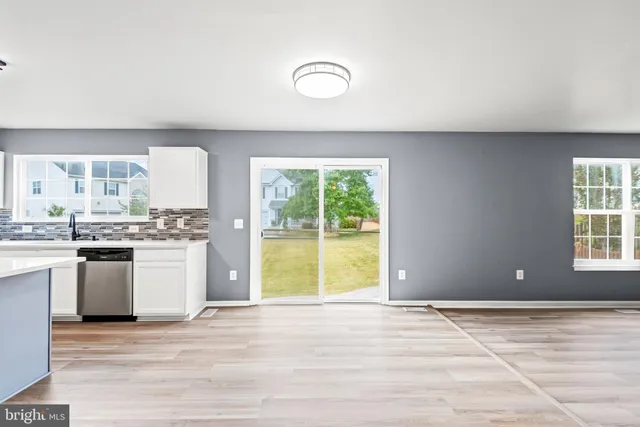 a view of a kitchen with a sink and a window