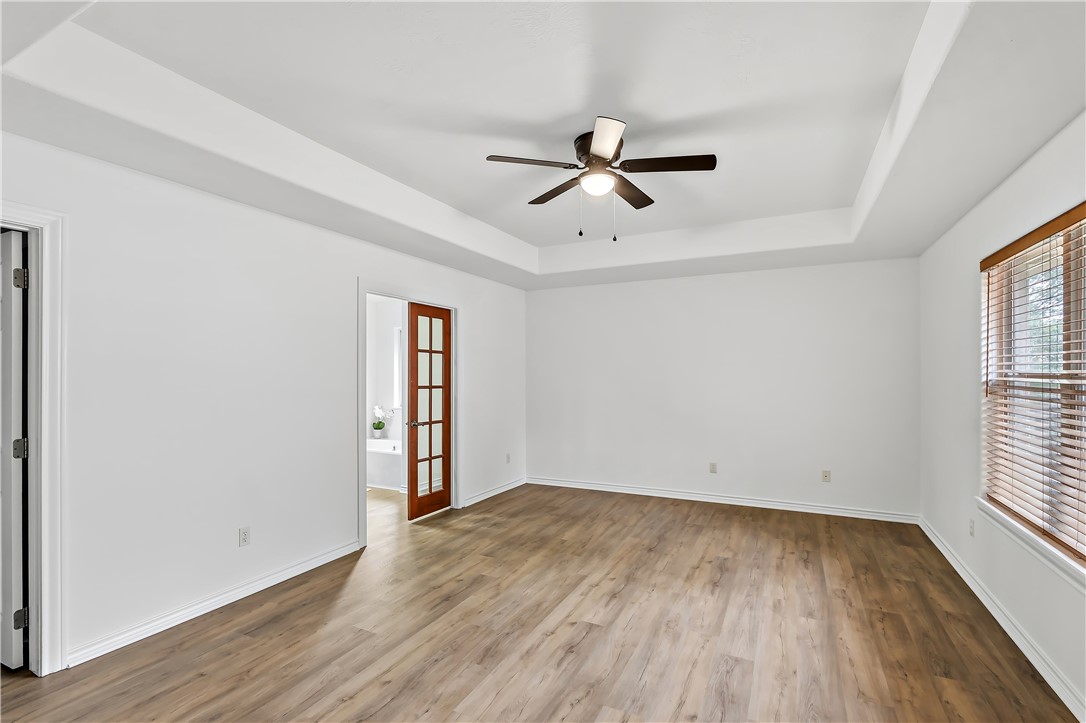 5310 Draycott Court Bryan, TX 77802 - Photo 22 of 31 an empty room with wooden floor fan and windows