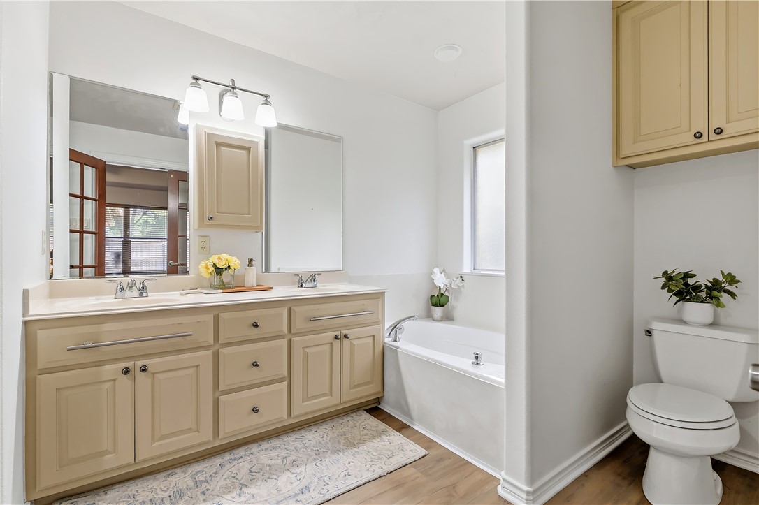 5310 Draycott Court Bryan, TX 77802 - Photo 24 of 31 a bathroom with a toilet sink and mirror