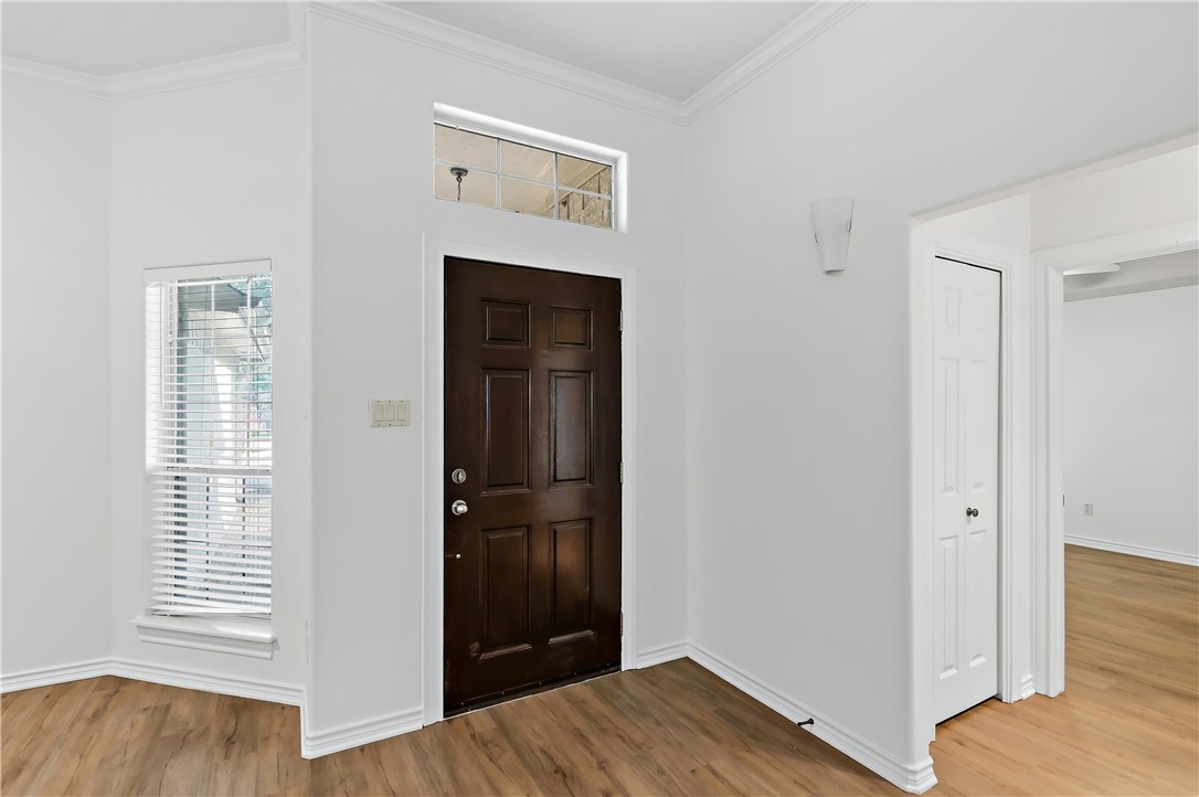 5310 Draycott Court Bryan, TX 77802 - Photo 4 of 31 a view of a bedroom with wooden floor and hallway