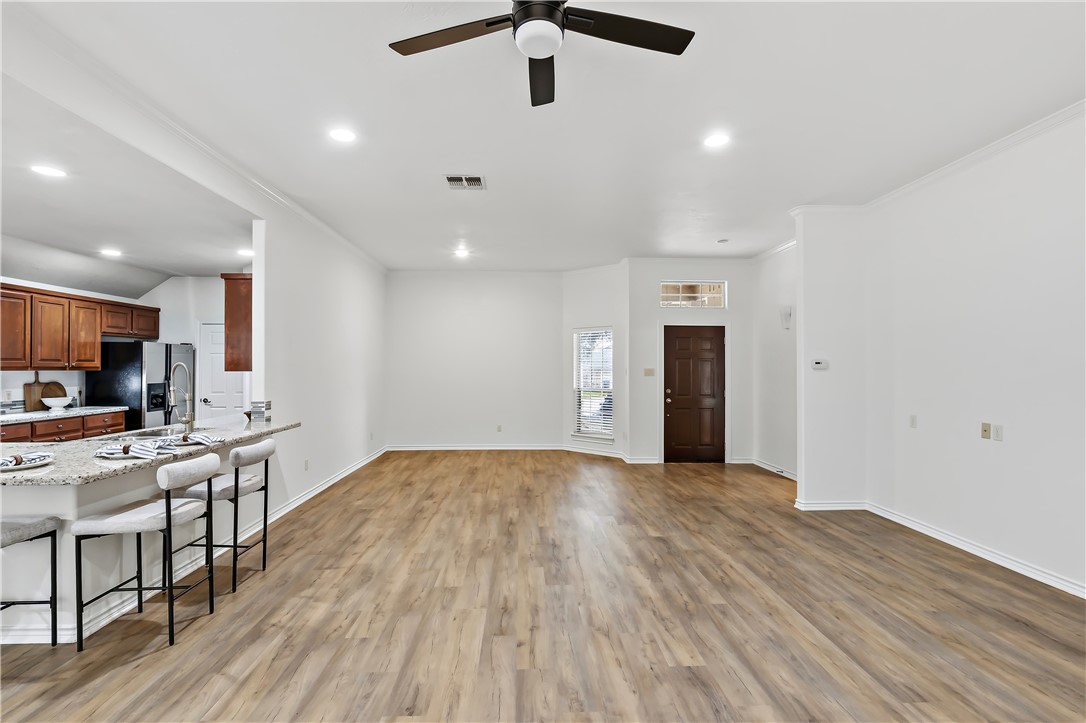 5310 Draycott Court Bryan, TX 77802 - Photo 10 of 31 a view of a kitchen with a sink and dishwasher a refrigerator with wooden floor