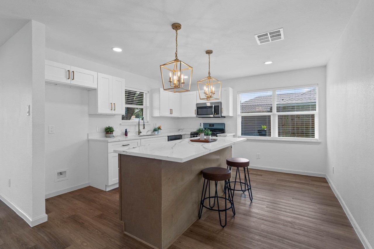 5326 Findlay Drive Pasadena, TX 77505 - Photo 16 of 50 Bright, remodeled kitchen featuring a large center island, quartz countertops, and an open dining area.