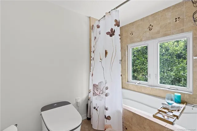 a bathroom with a toilet sink and shower