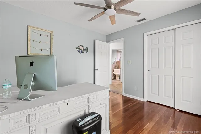 a view of a hallway with closet and wooden floor