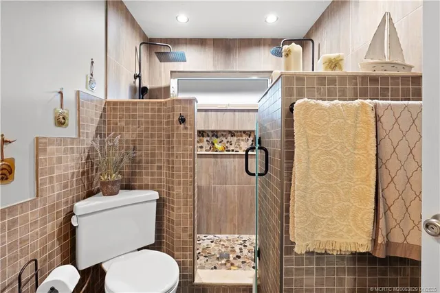 a bathroom with a toilet sink and shower