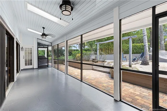 a view of a hallway with a ceiling fan