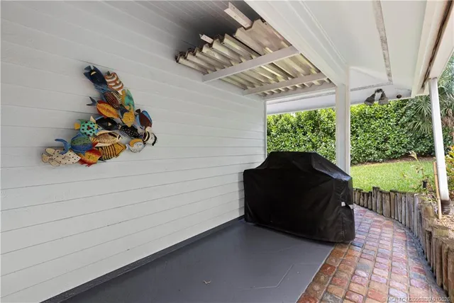 a view of a dinning room and hall with wooden fence