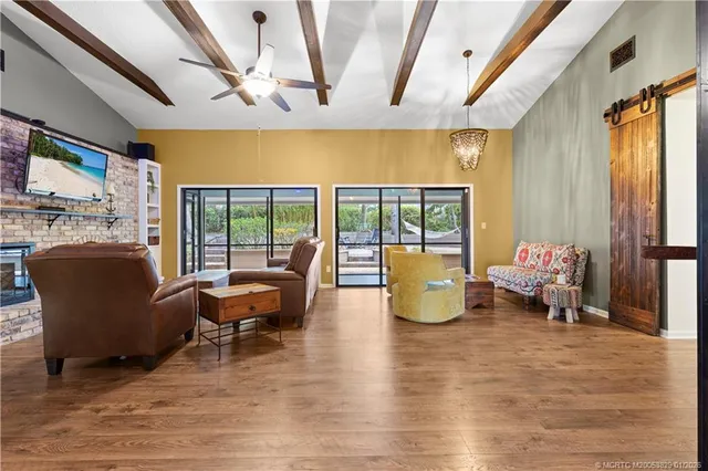 a living room with furniture and large windows