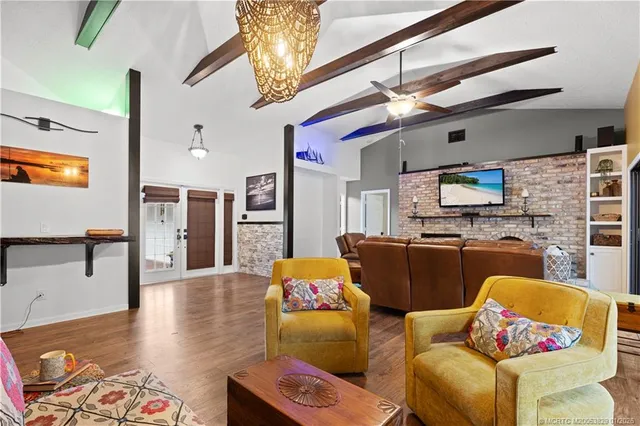 a living room with furniture and kitchen view