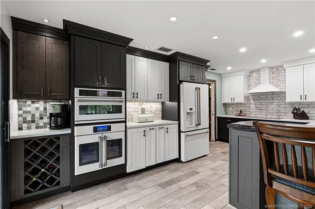 a kitchen with stainless steel appliances and refrigerator