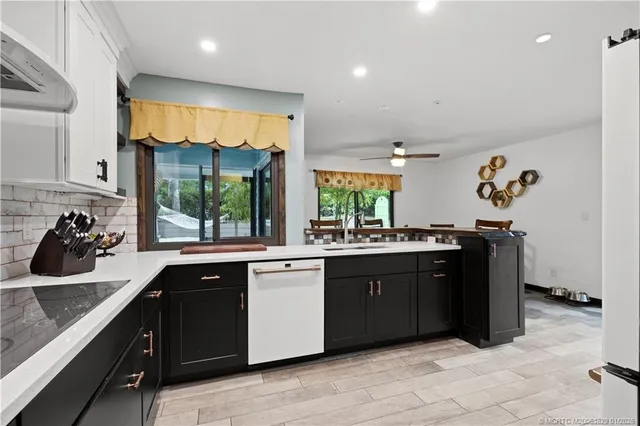 a kitchen with stainless steel appliances granite countertop a sink and a stove