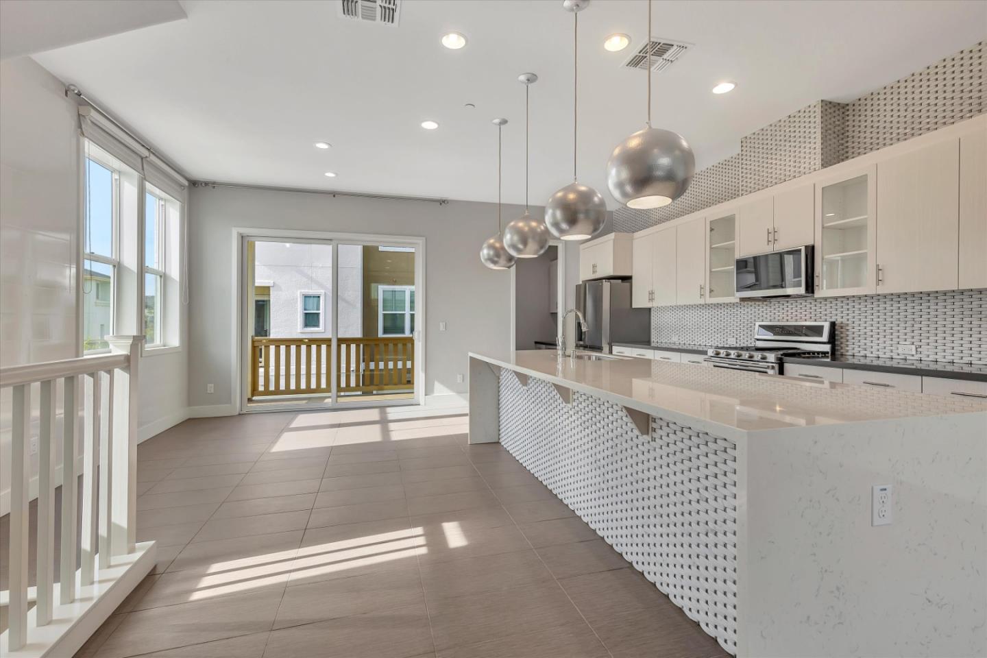 5533 Azalea Way Newark, CA 94560 - Photo 12 of 64 a large kitchen with kitchen island granite countertop a stove a sink a refrigerator and a dining table view
