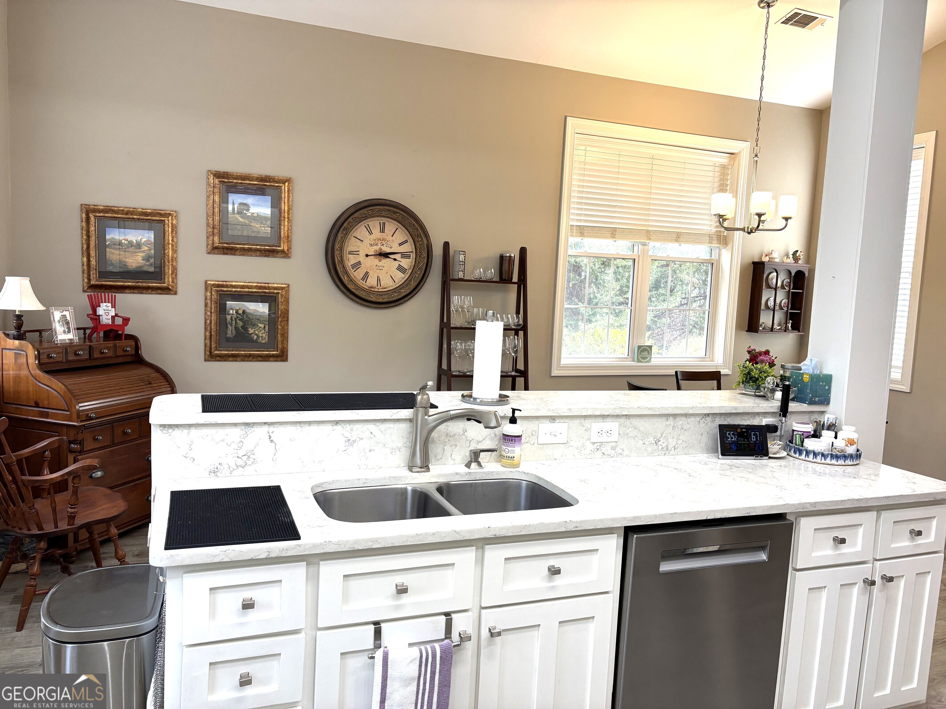 303 Winchester Court Dublin, GA 31021 - Photo 11 of 40 a kitchen with a stove a sink and a refrigerator with wooden floor