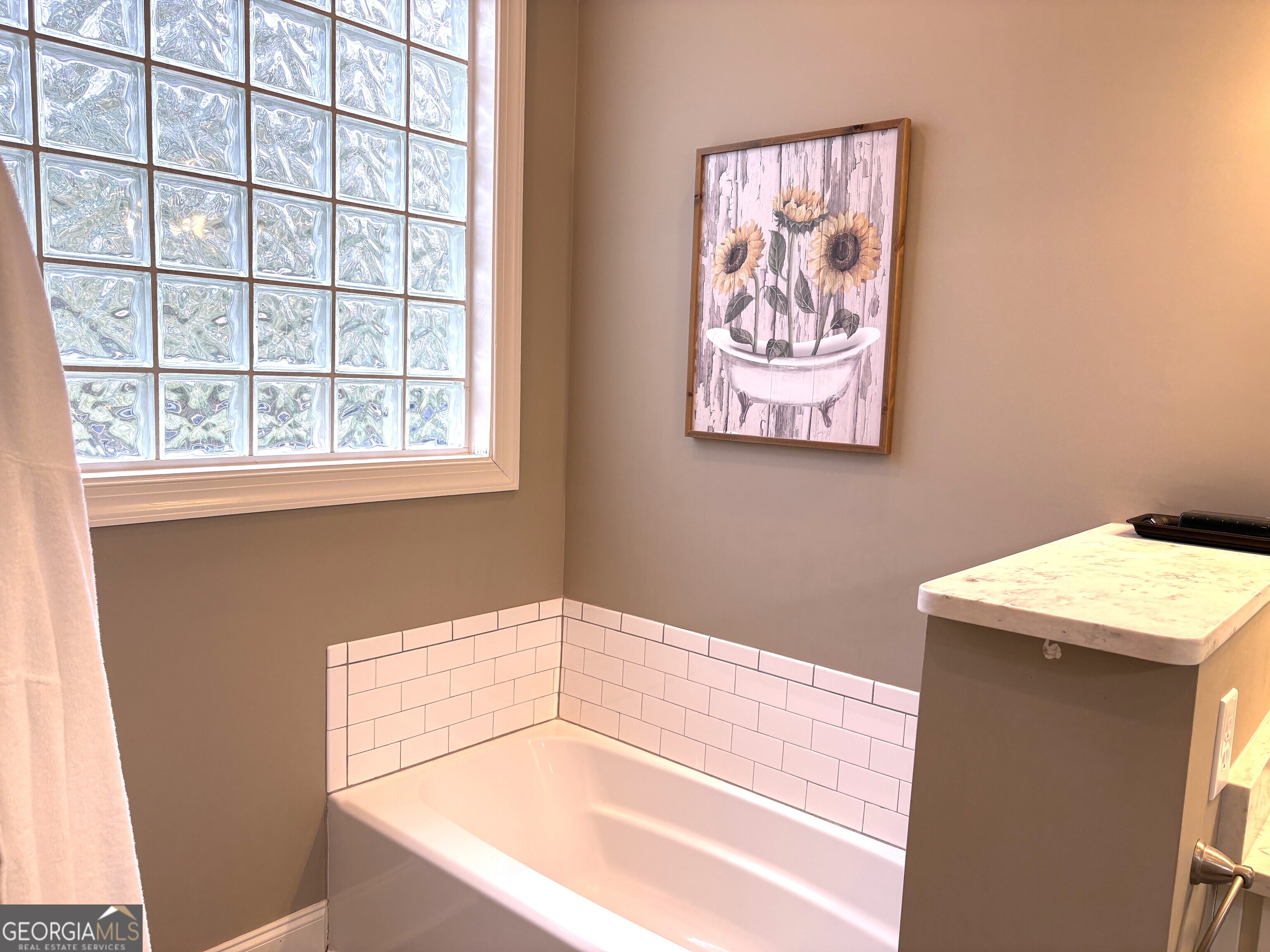303 Winchester Court Dublin, GA 31021 - Photo 17 of 40 a bathroom with a bathtub and a window