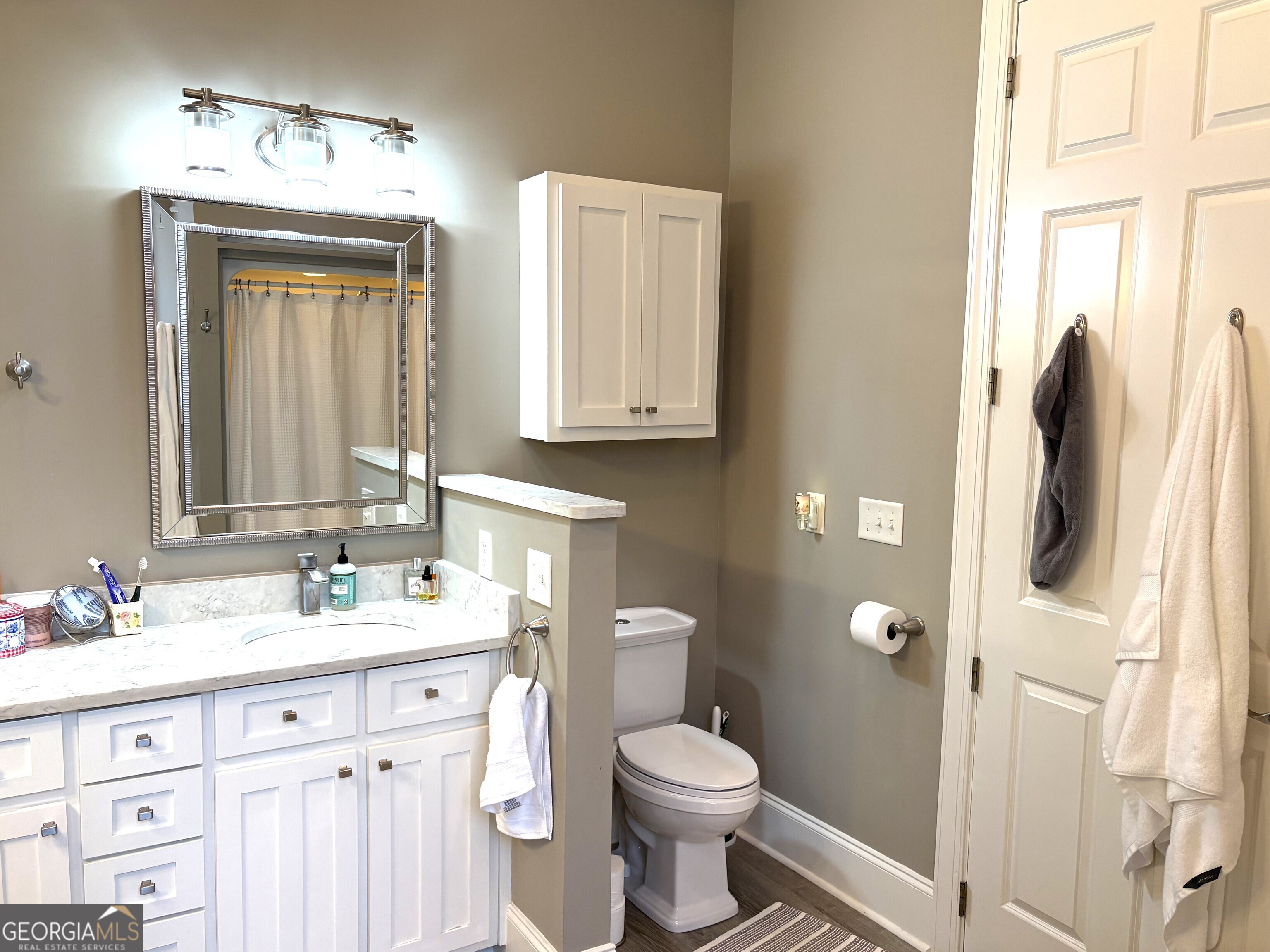 303 Winchester Court Dublin, GA 31021 - Photo 18 of 40 a bathroom with a granite countertop sink toilet and shower