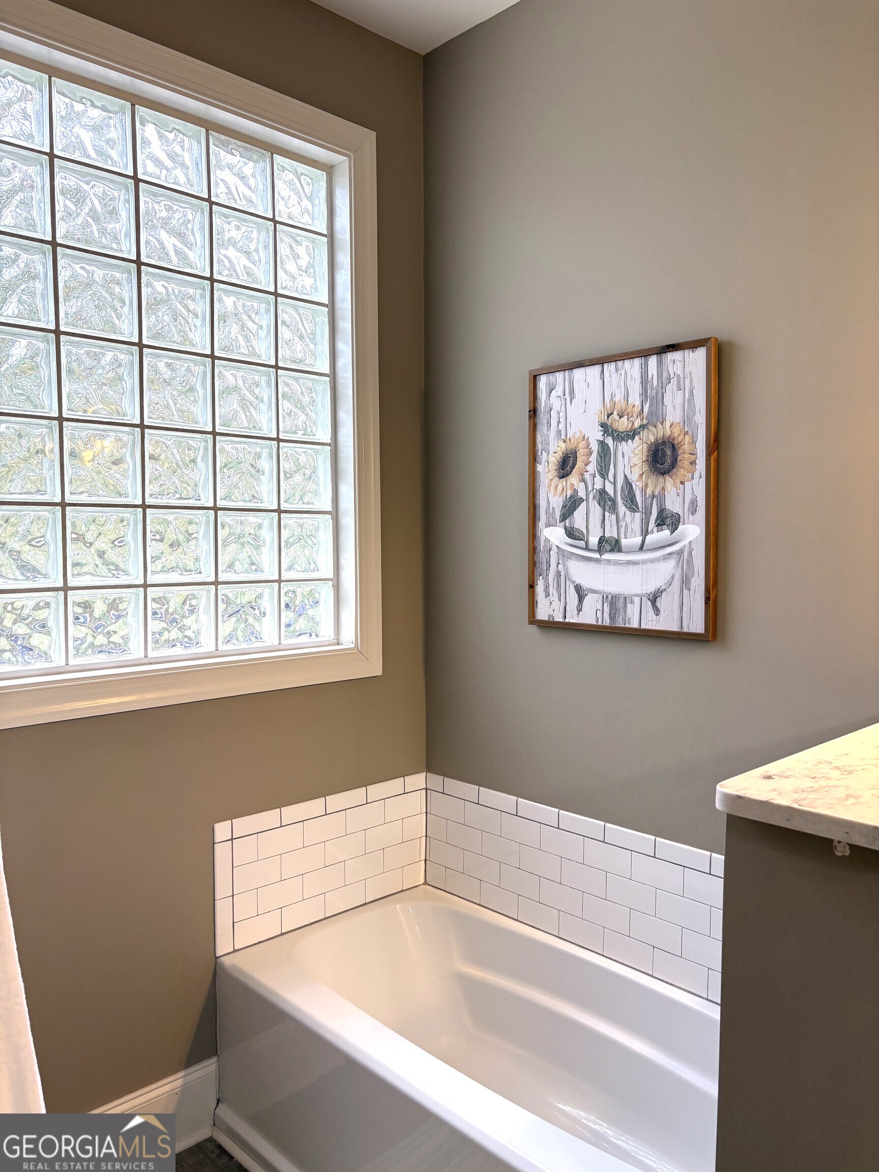 303 Winchester Court Dublin, GA 31021 - Photo 20 of 40 a bathroom with a bathtub and next to a window