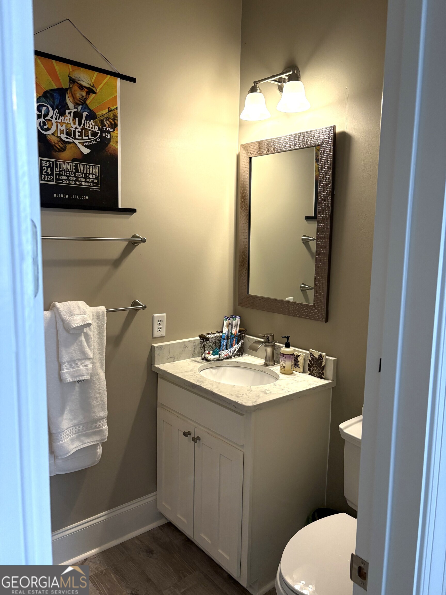 303 Winchester Court Dublin, GA 31021 - Photo 23 of 40 a bathroom with a toilet sink and mirror