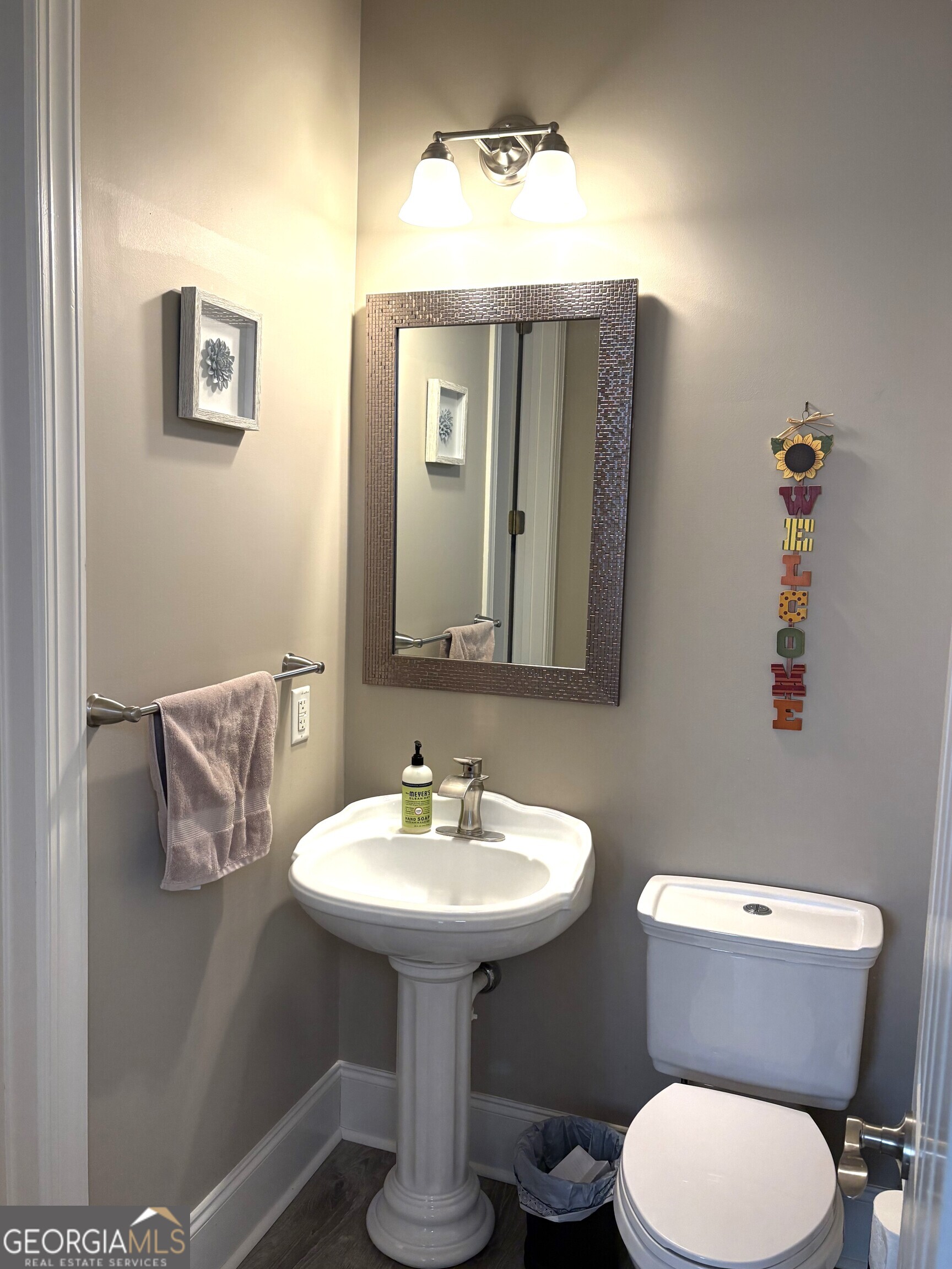303 Winchester Court Dublin, GA 31021 - Photo 26 of 40 a bathroom with a toilet sink and mirror