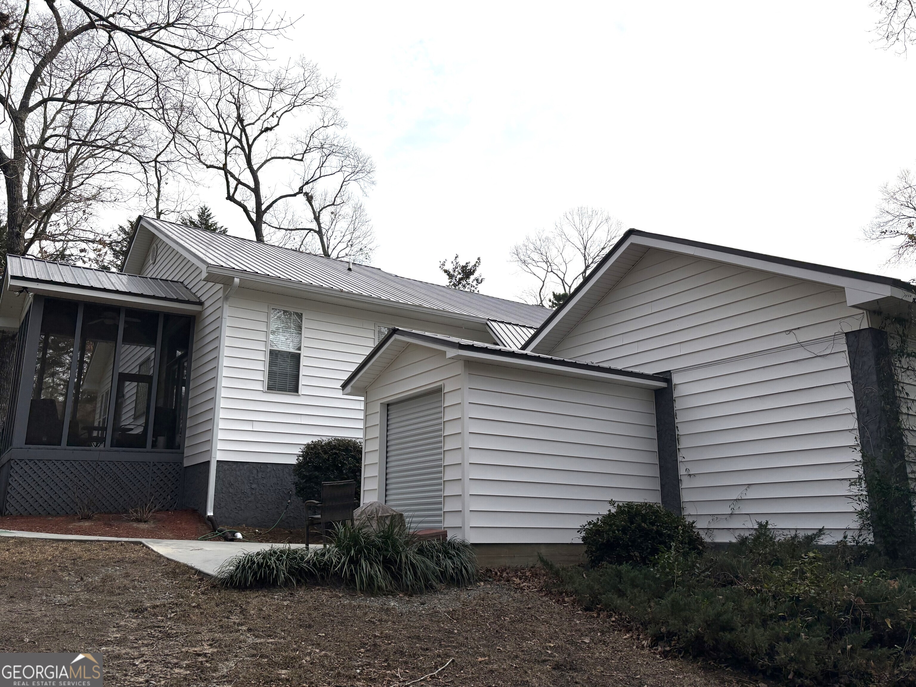 303 Winchester Court Dublin, GA 31021 - Photo 34 of 40 a view of a white house next to a yard and plants