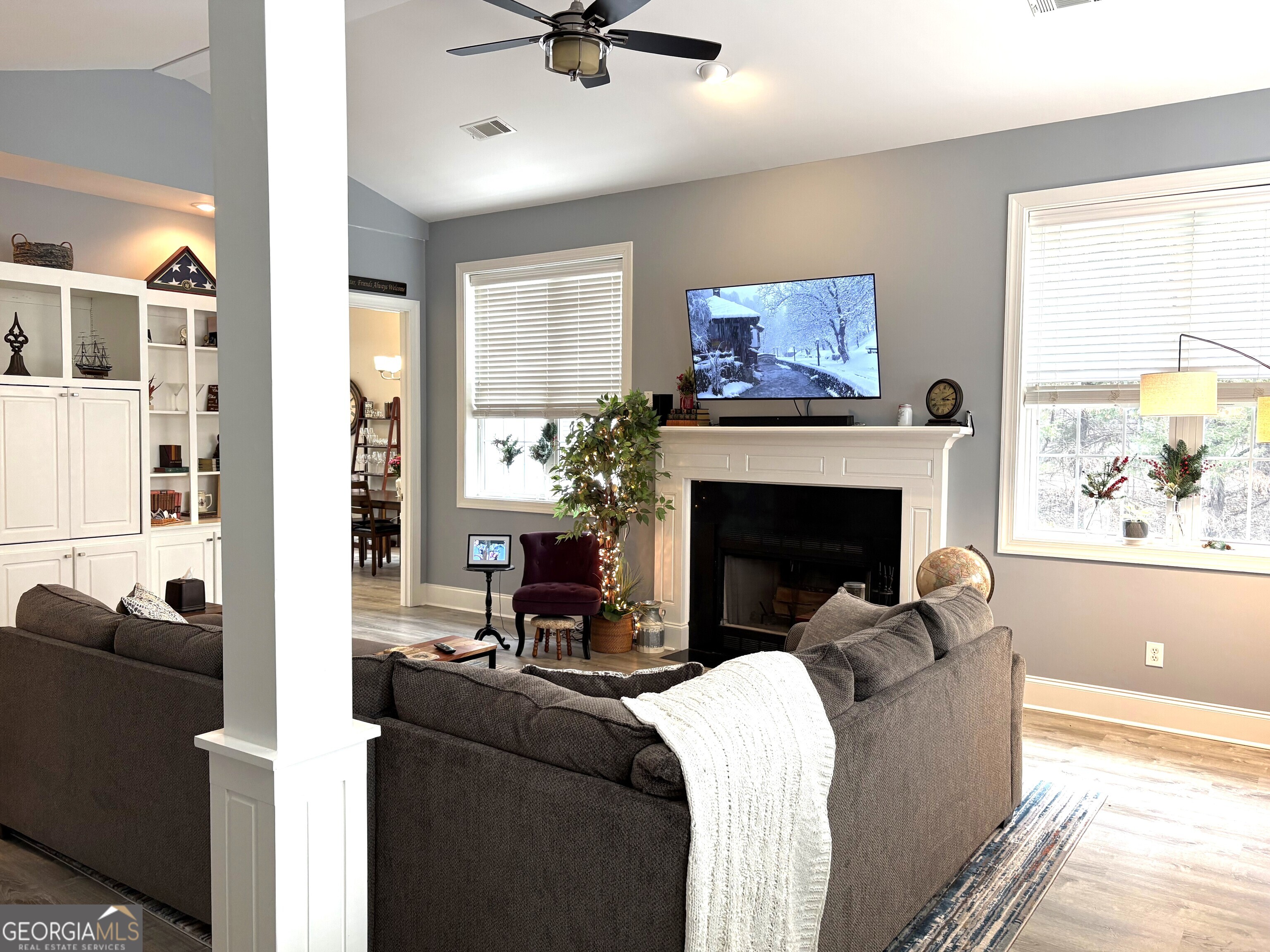 303 Winchester Court Dublin, GA 31021 - Photo 4 of 40 a living room with furniture a fireplace and a large window