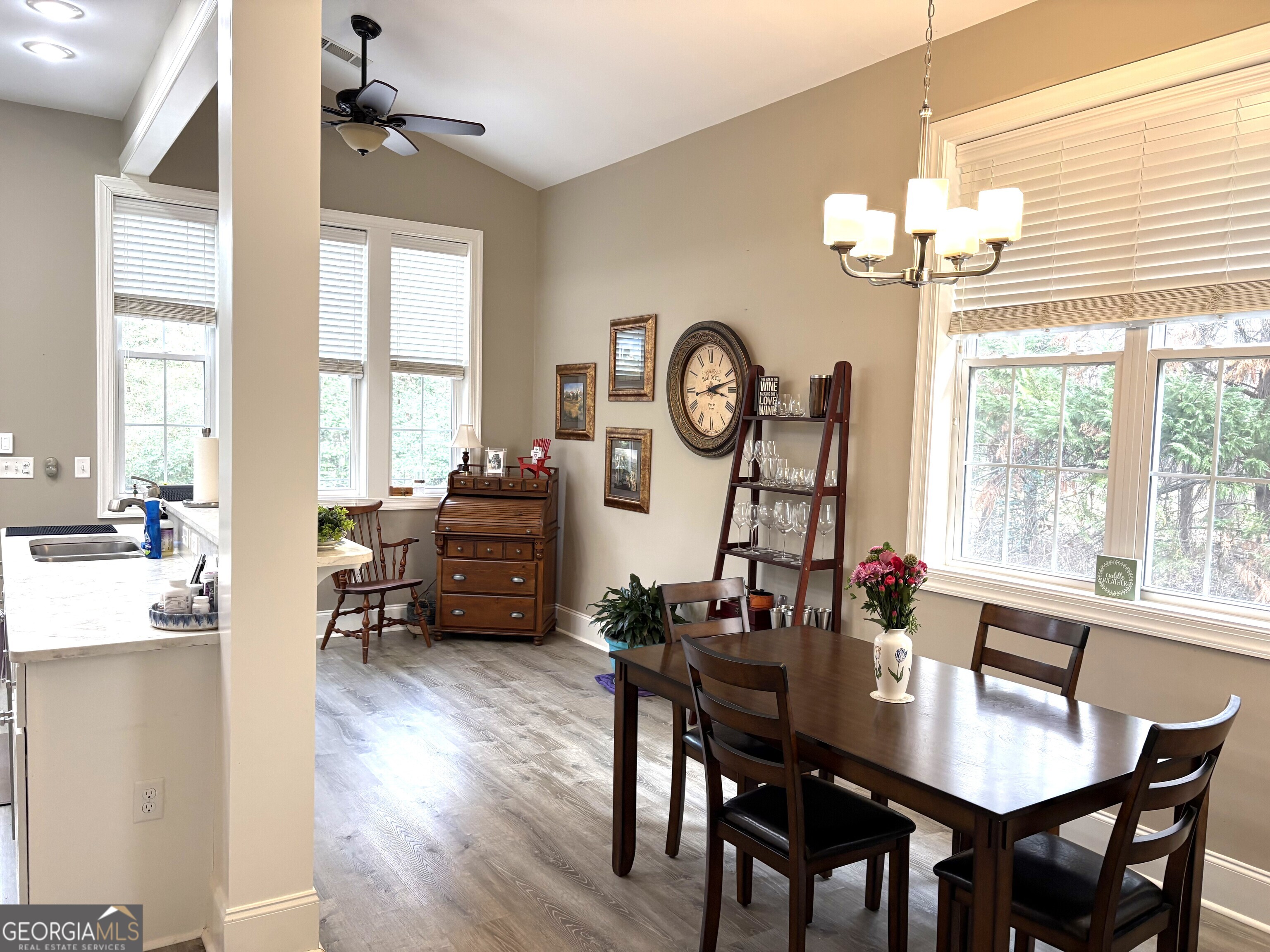 303 Winchester Court Dublin, GA 31021 - Photo 8 of 40 a living room with furniture a large window and a clock