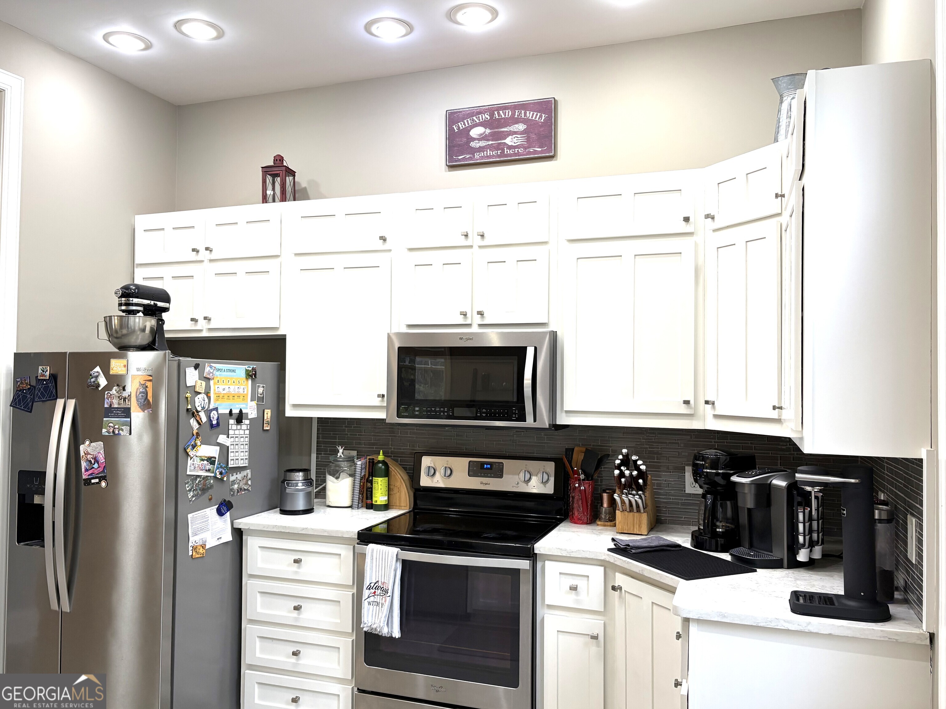 303 Winchester Court Dublin, GA 31021 - Photo 10 of 40 a kitchen with stainless steel appliances a stove refrigerator and cabinets