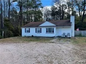 a backyard of a house with yard and outdoor seating