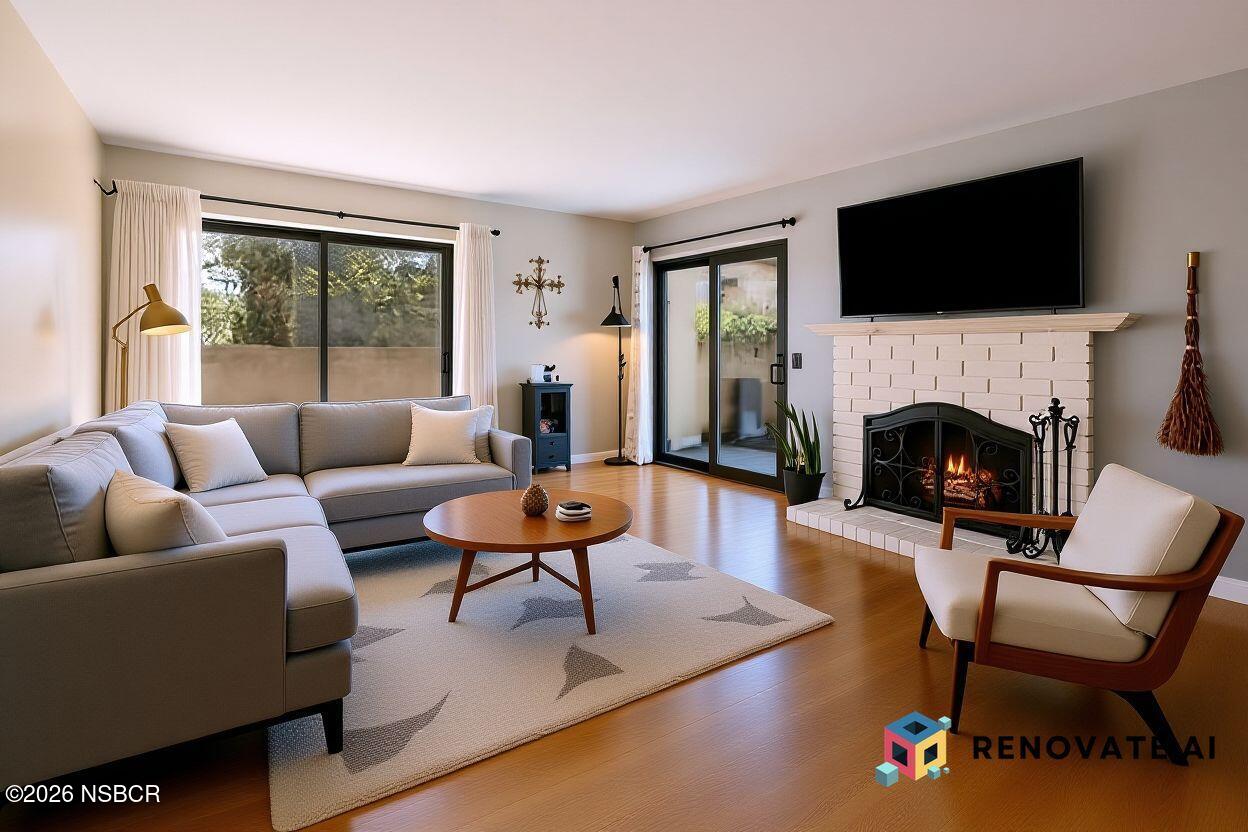639 Roskilde Road Solvang, CA 93463 - Photo 4 of 27 a living room with furniture a flat screen tv and a fireplace