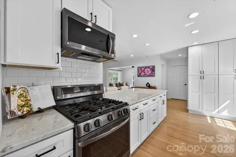 a kitchen with a stove and a microwave