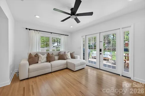 a living room with furniture and large windows