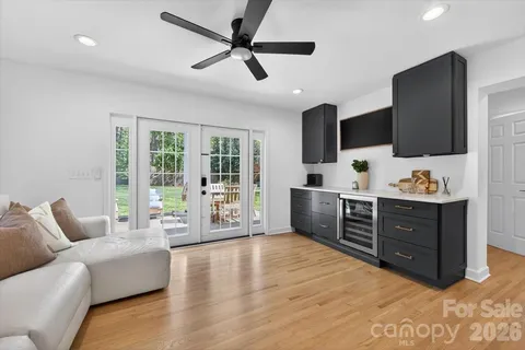 a living room with furniture flat screen tv and a floor to ceiling window