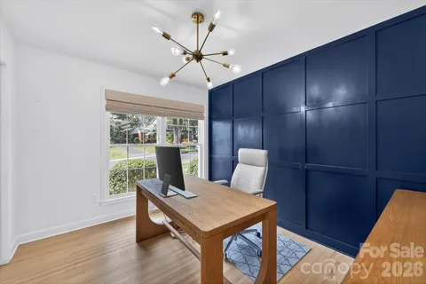 a view of a room with furniture wooden floor and fan