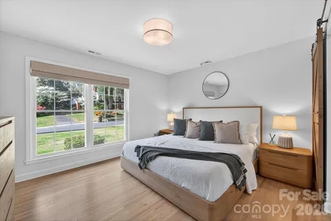 a bedroom with a large bed and a large window
