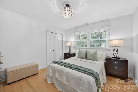 a bedroom with a bed and a lamp