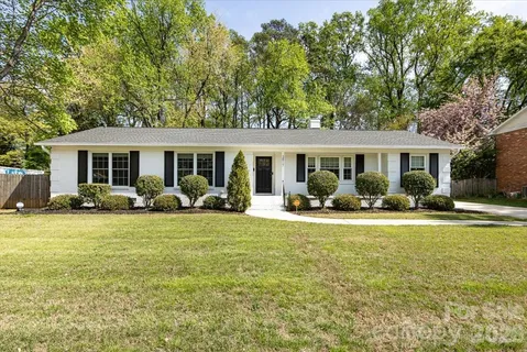 a view of a house with a patio and a yard