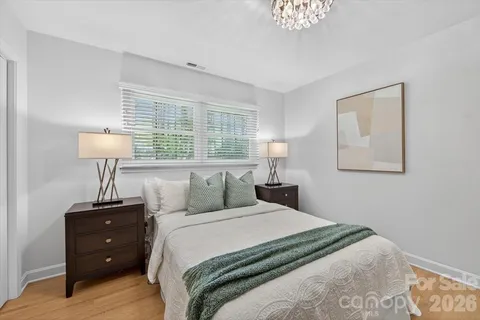 a bedroom with a bed and a lamp