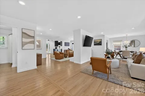 a living room with fireplace furniture and a wooden floor