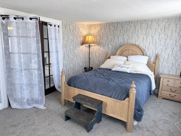 a bedroom with a bed and a bathroom