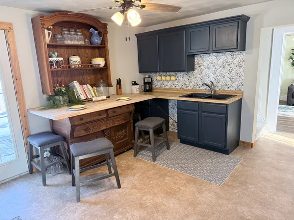 a kitchen with a refrigerator and cabinets
