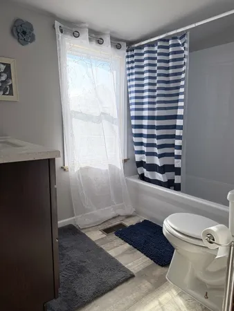a bathroom with a toilet and a shower curtain